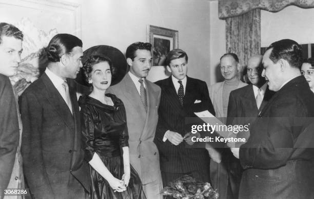 Dominican diplomat and socialite Porfirio Rubirosa stands next to American socialite and Woolworth's heiress Barbara Hutton during their wedding...