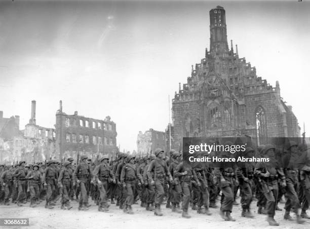 American troops marching through the ruins of Nuremberg.