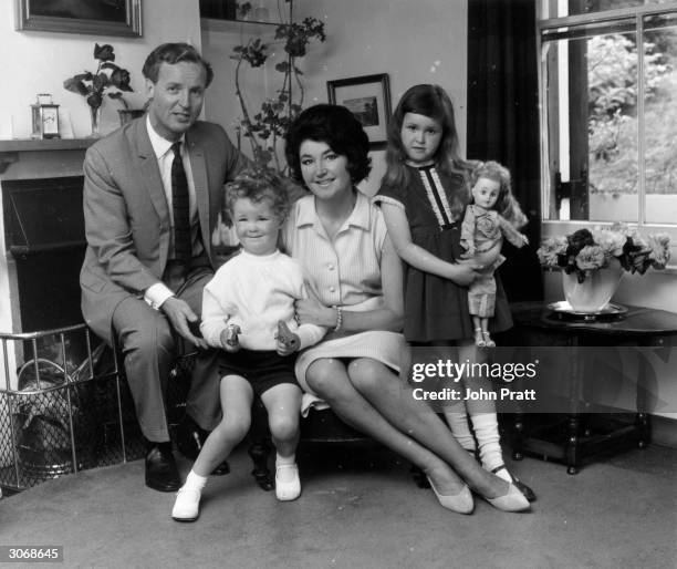 British light entertainer Nicholas Parsons and his wife Denise Bryer with their children Suzy and Justin at their Hampstead home.