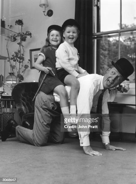 British light entertainer Nicholas Parsons with his children Suzy and Justin at their Hampstead home.