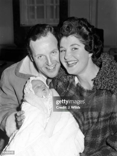 British light entertainer Nicholas Parsons and his wife Denise Bryer with their baby son Hugh Justin.