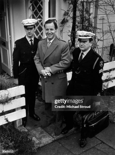 British light entertainer Nicholas Parsons with Securicor guards after a threat to kidnap him.