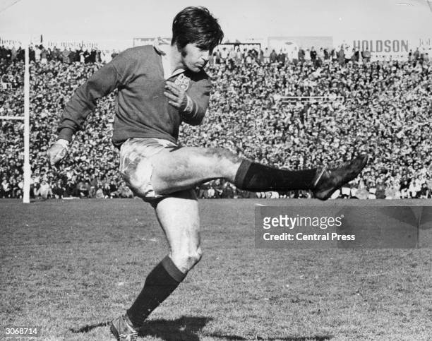Welsh rugby union fly-half Barry John playing with the British Lions against the All-Blacks at Auckland, during the 1971 tour, he broke the record...
