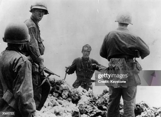 Japanese naval lieutenant, blood pouring from a head wound surrenders to the American army at Okinawa at the end of World War II. His surrender and...