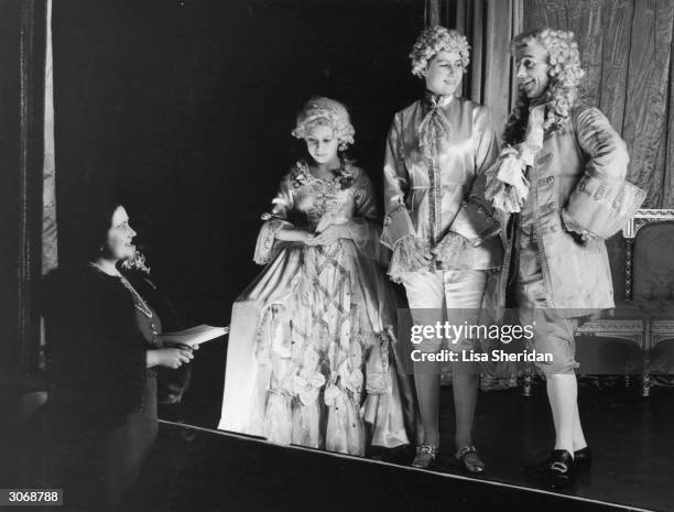 Queen Elizabeth, Princess Margaret and Princess Elizabeth during a rehearsal of 'Cinderella, the first Royal pantomime at Windsor Castle. The two...