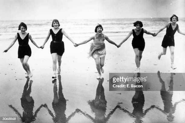 Members of the Brighton Swimming Club take advantage of an early summer to visit the beach.