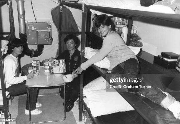 Phyllis Millet and her daughters Roberta and Katie having breakfast in their underground nuclear shelter during a five day trial.