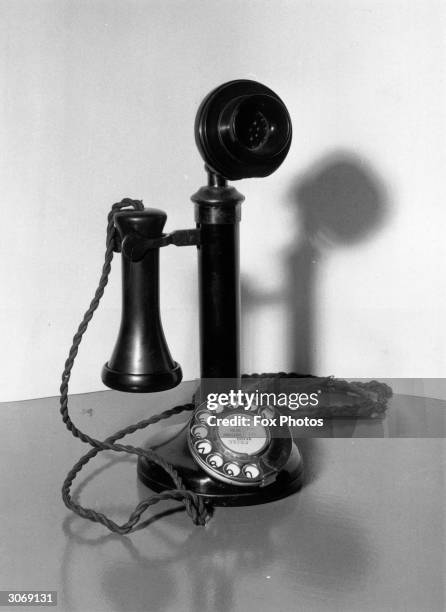 An old-fashioned candlestick telephone.