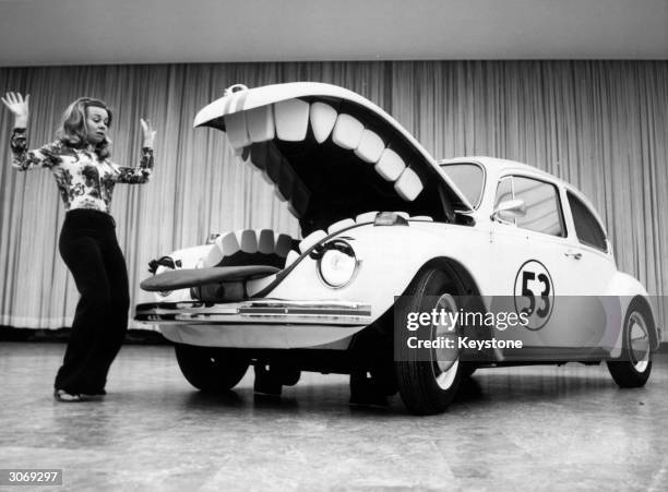 Herbie, the anthropomorphic Volkswagen Beetle featured in the Disney film 'The Love Bug' and its sequels, terrorises a young woman at a motorshow in...