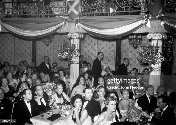 Movie stars Humphrey Bogart , Lauren Bacall, James Mason and Jennifer Jones spend a night out at the Cafe de Paris with entertainer Josephine Baker...