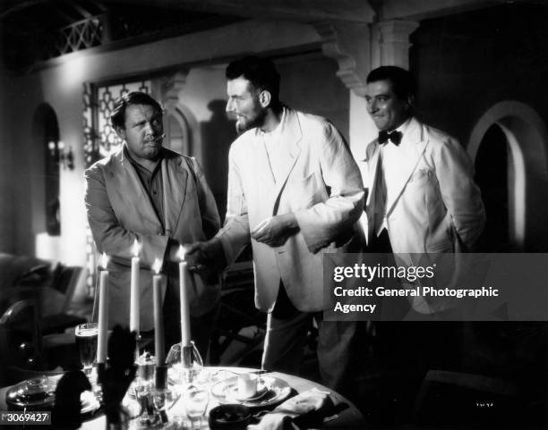 Tyrone Guthrie, Charles Laughton and Robert Newton in a scene from the film 'Vessel Of Wrath' adapted from the story by W Somerset Maugham.