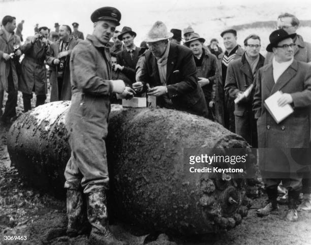 Flight Lieutenant James Waters and Walther Mitzke defuse a giant bomb which was dropped in the 1944 dam-busters raids in Landsheim, West Germany.