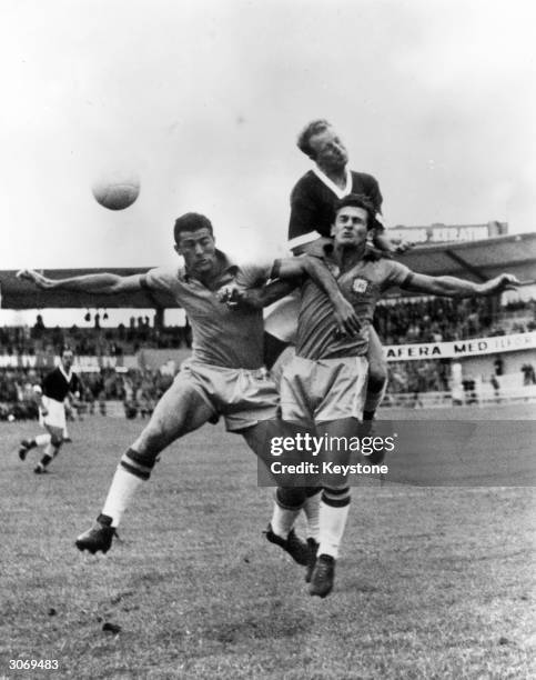 Ivor Allchurch of Wales jumping for the ball against Hideraldo Bellini and Nilton De Sordi of Brazil during their World Cup quarter final match in...