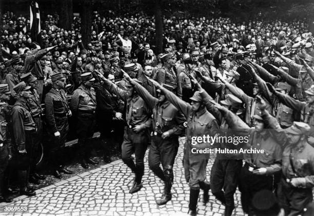 German dictator Adolf Hitler takes the salute at a Nazi parade in Germany.