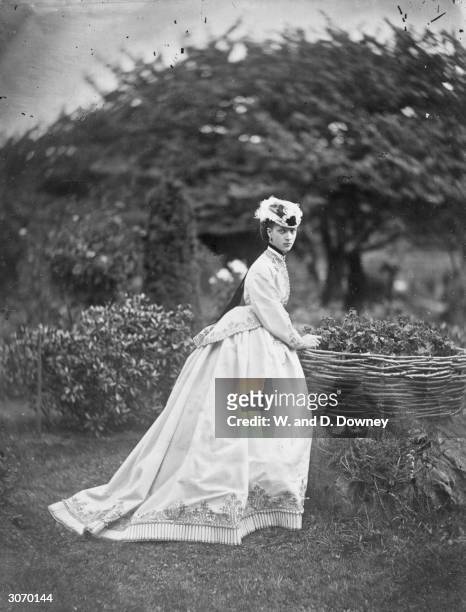 Alexandra, Princess of Wales , consort of Prince Edward, later King Edward VII, with a basket of geraniums.
