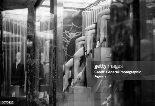 Display of sheer nylons in a shop window, possibly Harrods of London, during their Great Summer Sale.