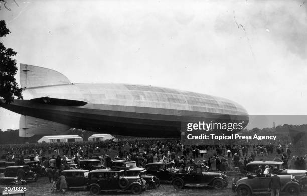 Crowds gather at Hanworth Park, Middlesex to witness the landing of the massive German Graf Zeppelin. German tourists disembarked from the aircraft,...