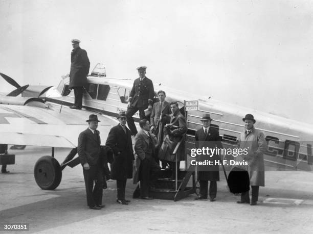 Officials about to enter a Spartan air cruiser for its inaugural flight from Croydon, north Sussex to the Isle of Wight. The flight links with a...