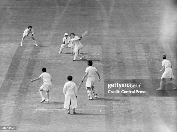 English cricketer Rachel Heyhoe-Flint hits Australian M Knee to the boundary during England's first innings against Australia in the Women's Cricket...