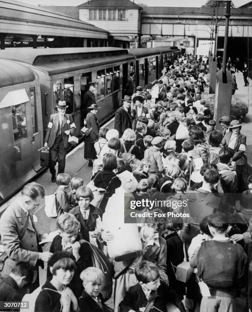 Schoolchildren crowd Ealing Broadway Station in London, some of the first youngsters to be evacuated to the country during World War II.