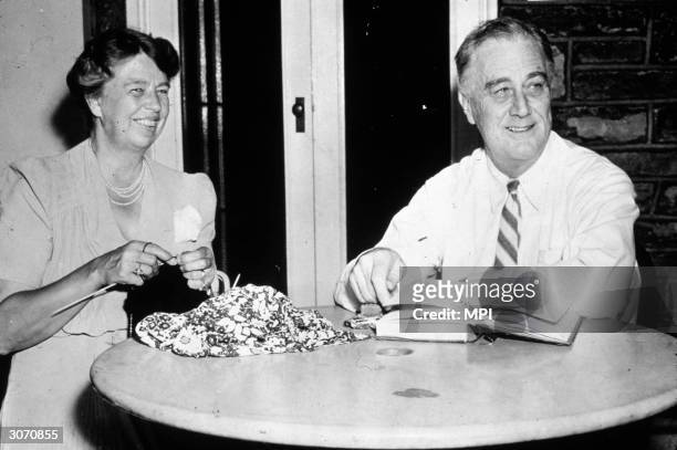 Franklin Delano Roosevelt , the 32nd president of the United States relaxing at home with his wife Eleanor. Together with Winston Churchill and...