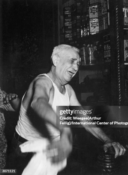 Landlord Henry Geller weeps over the loss of his tobacco shop and the death of a porter in a fire on East Houston Street, on New York's East Side.