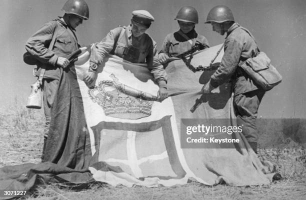 Russian troops in the Don Valley with the captured standard of an Italian Regiment.