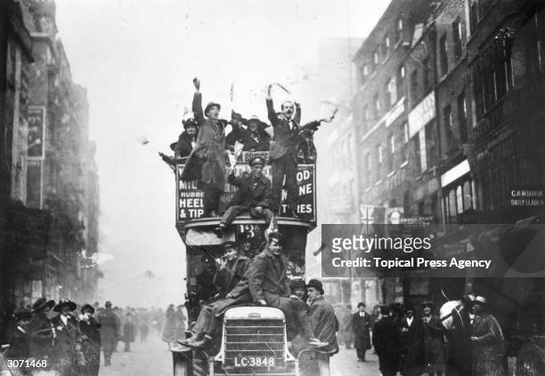 Crowds celebrating the signing of the Armistice at the end of World War I, UK, 11th November 1918.