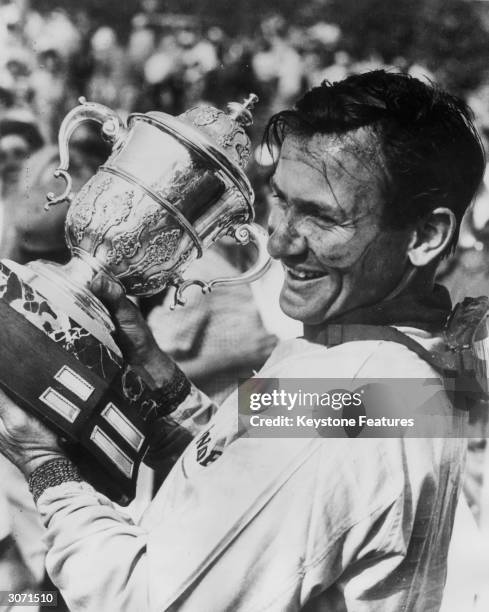 New Zealand racing driver Bruce McLaren celebrating after winning the Players 200 Mile sports car race at Mosport Park, near Toronto. Mclaren covered...