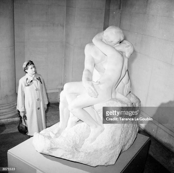 Visitor to the Tate Gallery in London admires one of the three marble originals of Auguste Rodin's 'The Kiss' . The statue's owner has announced...
