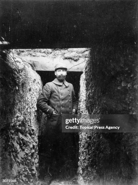 French soldier standing in the entrance to a trench.