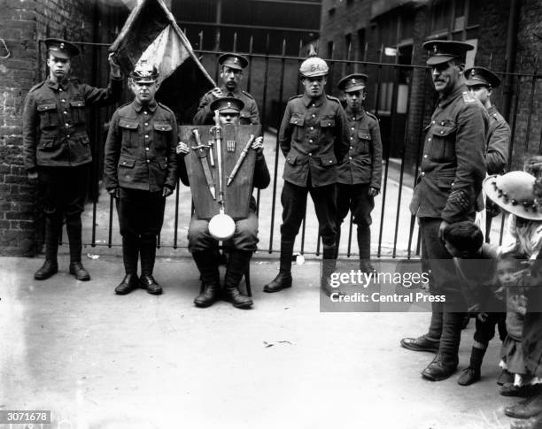 Group of British soldiers with captured German equipment.