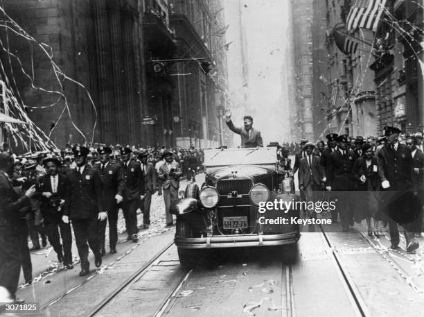 American aviator Wiley Post travelling down Broadway, New York, to his official reception after completing his first solo flight around the world.