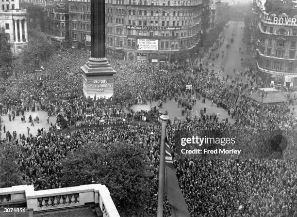 Day, held to commemorate the official end of World War II in Europe, is celebrated by crowds at Trafalgar Square in London, 8th May 1945.