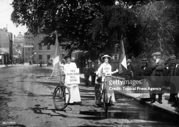 Two suffragettes advertising a meeting at which Emmeline Pankhurst will speak.