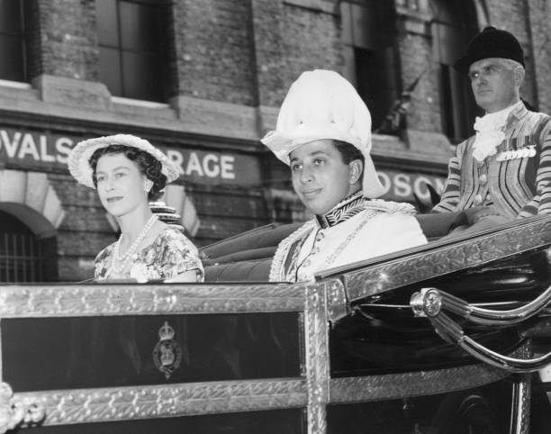 King Faisal II of Iraq and Queen Elizabeth II of Great Britain leaving Victoria Station, London, for Buckingham Palace.