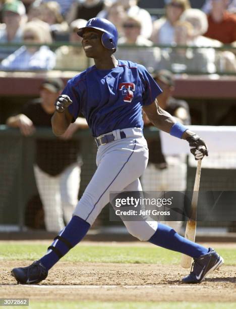 Alfonso Soriano of the Texas Rangers hits a single in the second inning during a spring training game against the San Francisco Giants on March 10,...