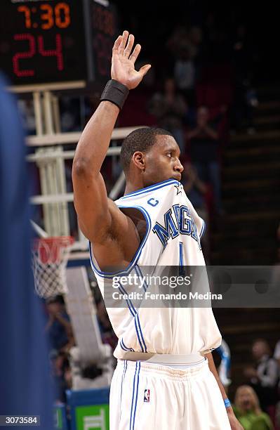 Tracy McGrady of the Orlando Magic waves to the crowd after scoring a career and franchise high 62 points against the Washington Wizards during a...