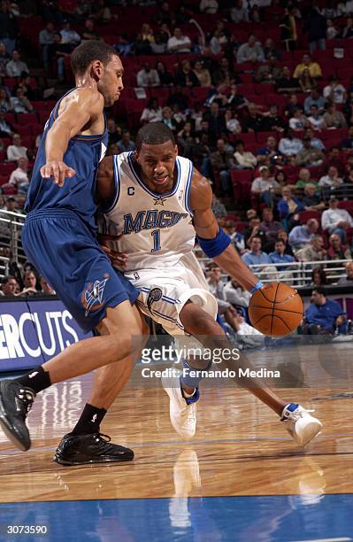 Tracy McGrady of the Orlando Magic dribbles past Jared Jeffries of the Washington Wizards during a game played at TD Waterhouse Centre on March 10,...
