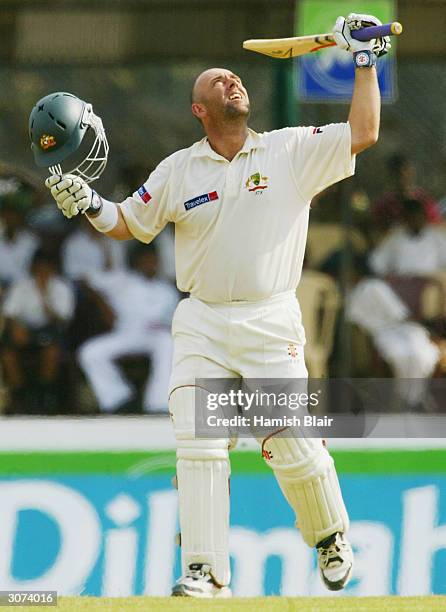 Darren Lehmann of Australia looks to the heavens in memory of former Australian cricketer David Hookes as he reaches his century during day four of...