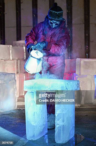 Dutch actress Daphne van Tongeren spills hot water on a block of ice during a rehearsal of the play "Eismitte" by Dutch director Jens-Erwin Siemssen,...