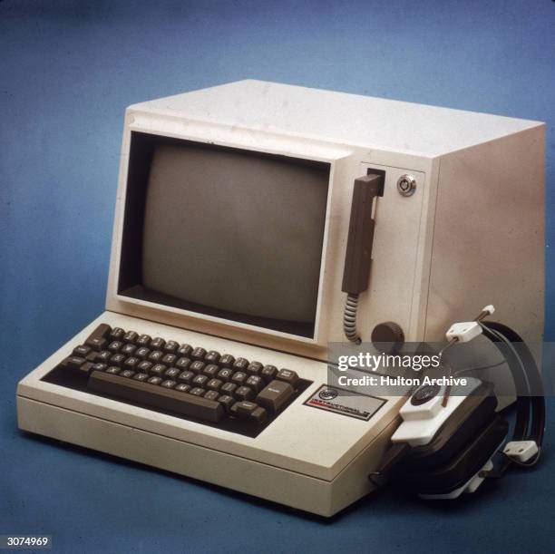 Still-life of a small RCA computer with the monitor and keyboard in one unit, alongside a set of headphones, 1970s.