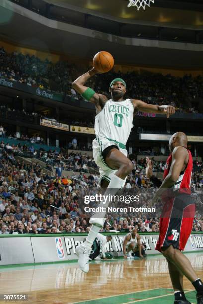 Walter McCarty of the Boston Celtics goes up for a dunk during the game against the Toronto Raptors at the Fleet Center in Boston, Massachusetts on...