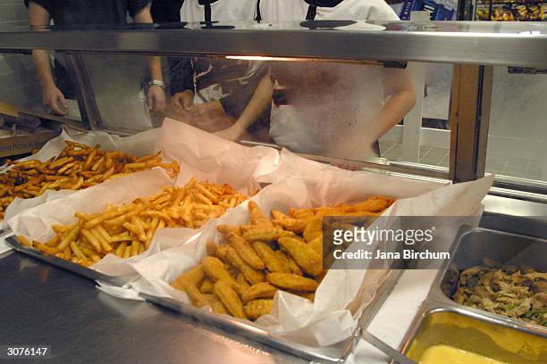 Students line up to receive food during lunch in the cafeteria at Bowie High School March 11, 2004 in Austin, Texas. The Austin School District is...