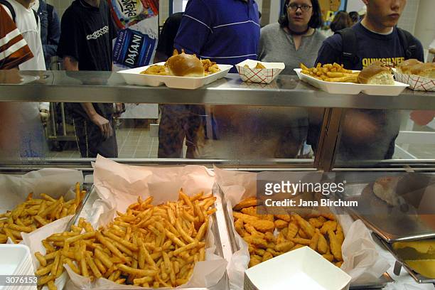 Students line up to receive food during lunch in the cafeteria at Bowie High School March 11, 2004 in Austin, Texas. The Austin School District is...