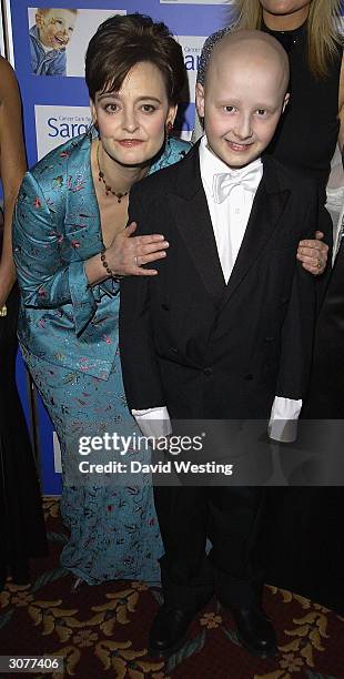 Cherie Blair QC, the Patron of the Charity and the Prime Minister's wife, poses for a picture with a boy at The Chocolate Ball March 11, 2004 at Cafe...