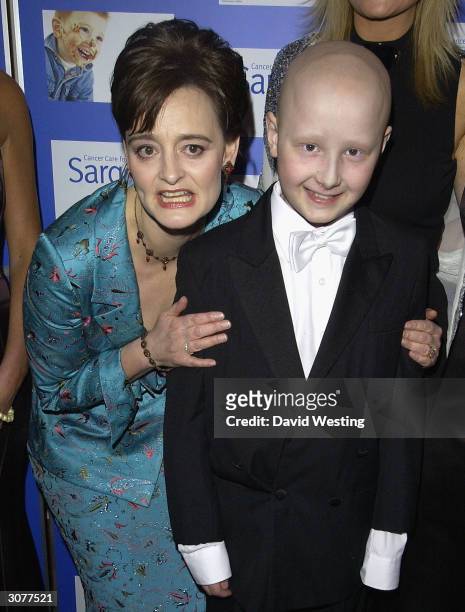 Cherie Blair QC, the Patron of the Charity and the Prime Minister's wife, poses for a picture with a boy at The Chocolate Ball March 11, 2004 at Cafe...