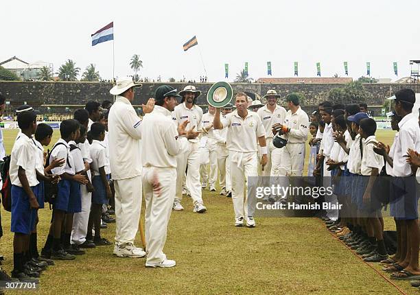 Shane Warne of Australia leaves the field at the end of the match after taking his 500th career wicket during day five of the First Test between...