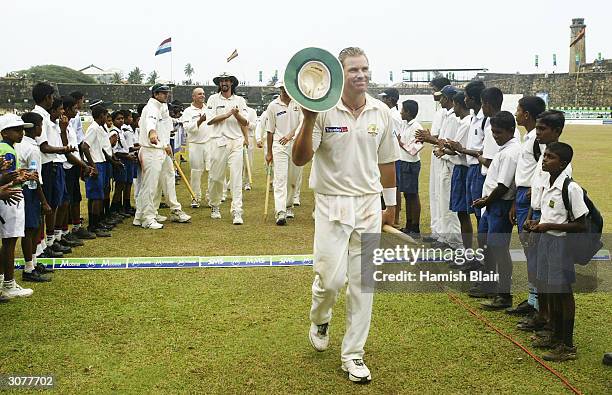 Shane Warne of Australia leaves the field at the end of the match after taking his 500th career wicket during day five of the First Test between...