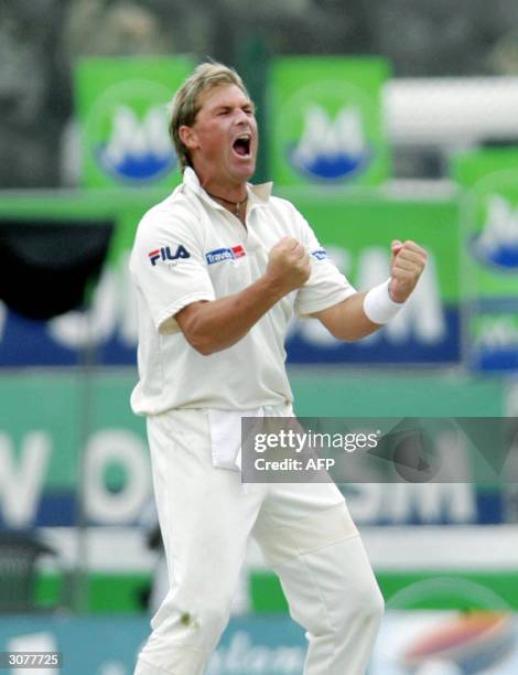 Australian cricketer Shane Warne gestures as he celebrates after dimissing Sri Lankan captain Hashan Tillakaratne bringing him to a total of 500 Test...